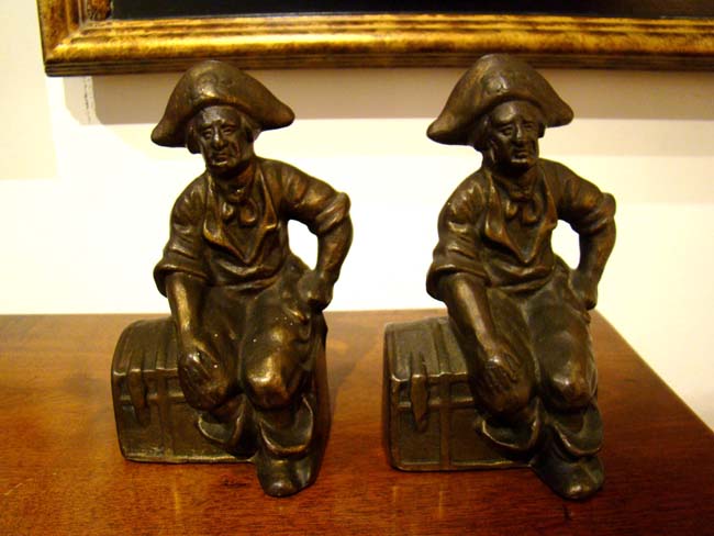 A pair of early 'Pirate sitting on a treasure chest' bookends by Hubley Mfg. circa 1915